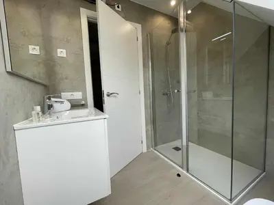 a bathroom with a shower and a sink at Adosado A ( 5 hab) in Foz