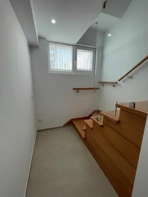 an empty room with stairs and a window at Adosado A ( 5 hab) in Foz