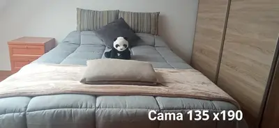 a stuffed panda bear is sitting on a bed at DÚPLEX ÁTICO XANA FOZ con terraza 80 m2 privada y vistas a la ría in Foz