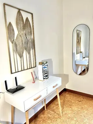 a white console table in a white room with a mirror at Casa en Cambeo in Ourense