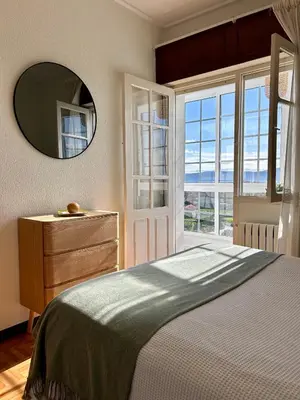 a bedroom with a bed and a mirror and a dresser at Casa en Cambeo in Ourense