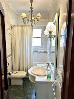 a bathroom with a sink and a toilet and a mirror at Casa en Cambeo in Ourense