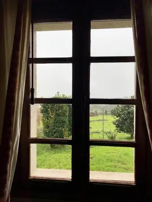 an open window with a view of a field at Casa en Cambeo in Ourense