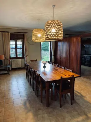 a dining room with a wooden table and chairs at Casa en Cambeo in Ourense