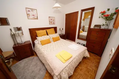 a bedroom with a bed and a large mirror at Antoxos Sacra Home I in Chantada