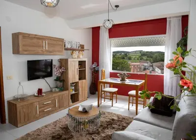 a living room with a couch and a table with a television at Antoxos Sacra Home I in Chantada