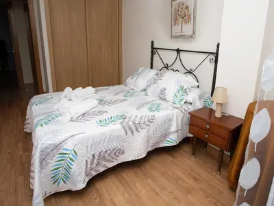 a bedroom with a bed with towels on it at VIVAVI piso in Sarria