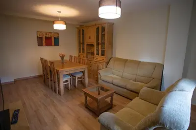 a living room with a couch and a table at VIVAVI piso in Sarria