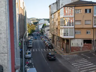 a view of a city street with cars parked at VIVAVI piso in Sarria