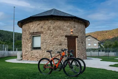 two bikes parked in front of a stone building at Pallozas Turisticas Ridicodias - A Pedra in Matamá
