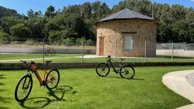 two bikes parked in the grass in a park at Pallozas Turisticas Ridicodias - A Pedra in Matamá