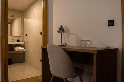 a desk with a chair and a lamp in a room at Viña Femita in Villafranca del Bierzo