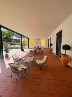 a large room with tables and chairs and windows at Viña Femita in Villafranca del Bierzo