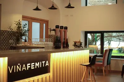 a bar in a restaurant with chairs and a counter at Viña Femita in Villafranca del Bierzo