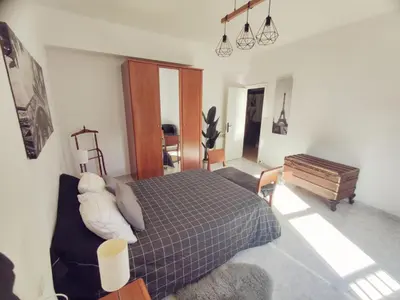 a bedroom with a bed and a couch and a piano at Quiroga centro paradise in Quiroga