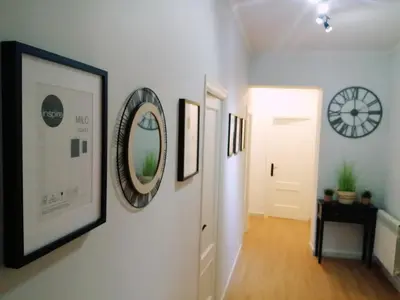 a hallway with framed pictures and a clock on the wall at Quiroga centro paradise in Quiroga