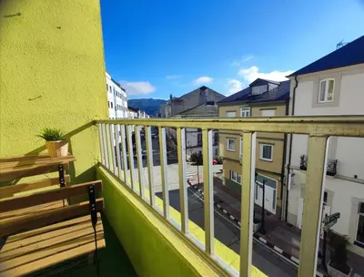 a balcony with a wooden bench on a building at Quiroga centro paradise in Quiroga