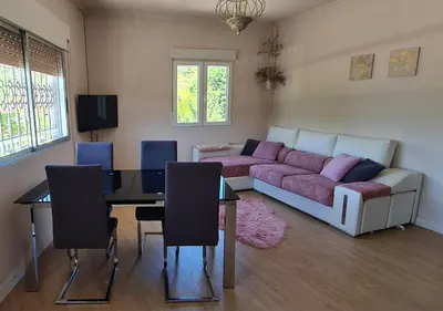 a living room with a couch and a table at Casita del Río Ourense in Ourense