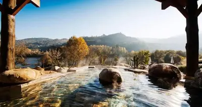 a hot tub with a view of a mountain at Casita del Río Ourense in Ourense