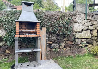 a bird house sitting next to a stone wall at Casita del Río Ourense in Ourense