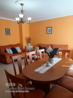 a dining room with a table and a couch at Aloha Barreiros in Barreiros
