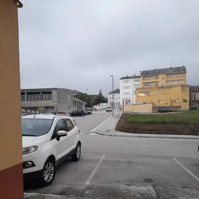a white car parked on the side of a street at Aloha Barreiros in Barreiros
