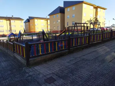 a park with a playground with a fence with books at Aloha Barreiros in Barreiros