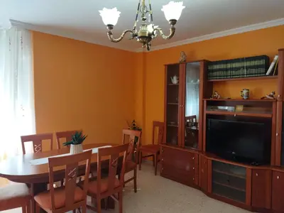 a dining room with a dining table and a television at Aloha Barreiros in Barreiros
