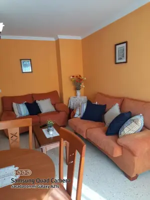 a living room with two couches and a table at Aloha Barreiros in Barreiros