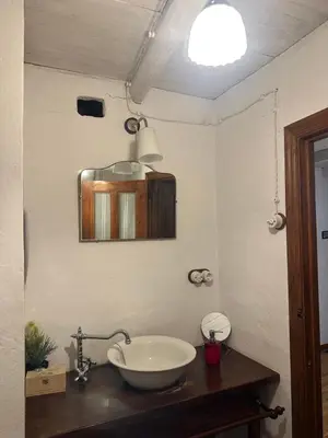 a bathroom with a sink and a mirror at Casa rural **** El Barreiro. Ideal para familias. in Sorbeda