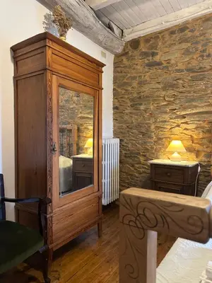 a bedroom with a large wooden cabinet with a mirror at Casa rural **** El Barreiro. Ideal para familias. in Sorbeda