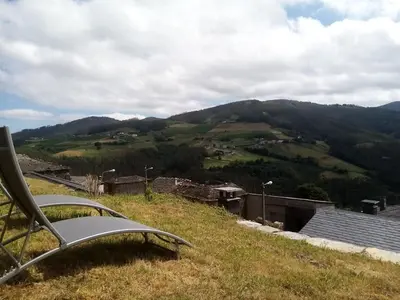 a chair sitting on top of a hill with a view at PiluPeta Casa de Aldea in Goje