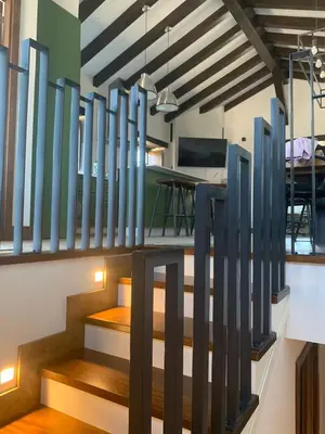 a room with a staircase with blue glass partitions at PiluPeta Casa de Aldea in Goje