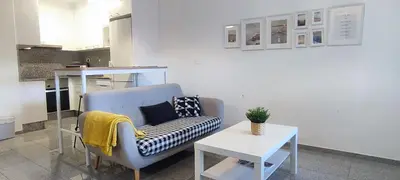 a living room with a couch and a table at Precioso apartamento en ares in Ares