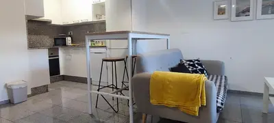 a kitchen with a table and some chairs in it at Precioso apartamento en ares in Ares