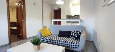 a living room with a couch and a table at Precioso apartamento en ares in Ares