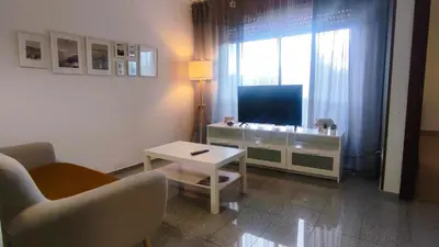 a living room with a tv and a couch and a table at Precioso apartamento en ares in Ares