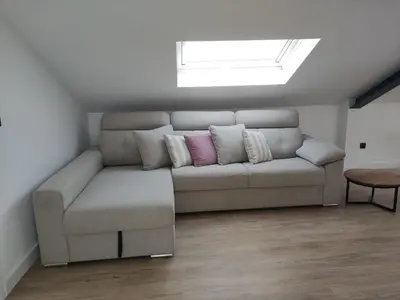 a living room with a couch with two pillows at POLAS BEACH LOFT in Nois