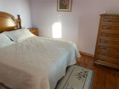 a bathroom sink with a mirror and a vase of flowers at Casa do Cuco, Ribeira Sacra in Ourense