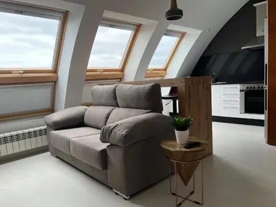 a living room with a couch and a table at BALCÓN DO MARIÑEIRO in Burela de Cabo