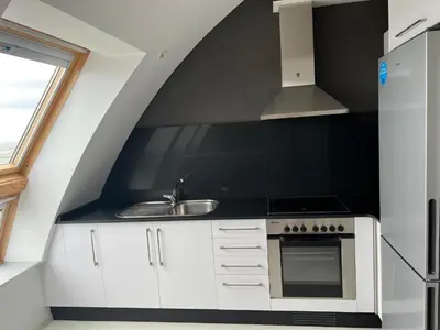 a white kitchen with a stove and a sink at BALCÓN DO MARIÑEIRO in Burela de Cabo