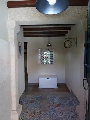 a white table in a room with a window at Hostel & Rooms Casa Maia in Padrón