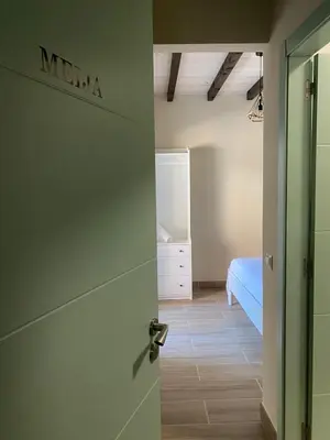a door leading to a bedroom with a bed at Hostel & Rooms Casa Maia in Padrón