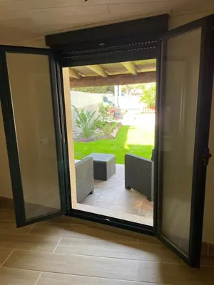 a sliding glass door with a view of a patio at Hostel & Rooms Casa Maia in Padrón