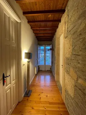 a hallway with a wooden floor and a ceiling with a door at Casa Grande de Láncara in Lugo