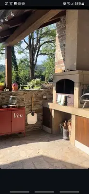 a kitchen with a stove and a stone wall at Casa Grande de Láncara in Lugo
