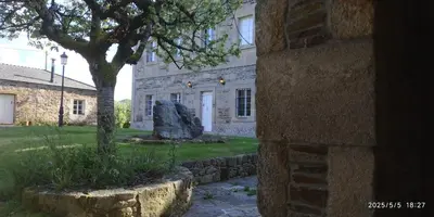 a stone building with a tree in front of it at Casa Grande de Láncara in Lugo