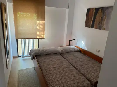 a bedroom with a bed in a room with a window at Apartamento Centrico y Tranquilo El Rinconcito in Ourense