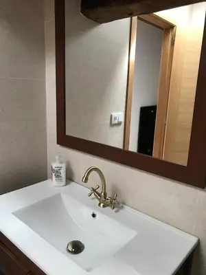 a bathroom sink with a large mirror above it at Casa Cea in Melide