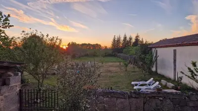 a view of a yard with a building and a fence at Casa da Penela in Nogueira de Ramuin